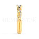 Anillo de compromiso estilo clúster, resalta un hermoso diamante forma brillante oval central y un ruedo de diamantes adicionales en forma de flor.