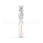 Anillo de compromiso estilo clúster, resalta un hermoso diamante forma brillante oval central y un ruedo de diamantes adicionales en forma de flor.